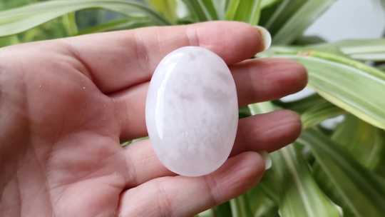 Pink calcite palm stone